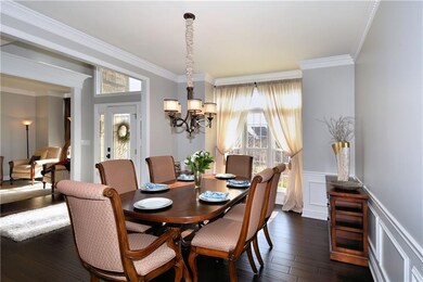 Formal dining room offers wainscoting and new chan
