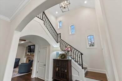 Staircase with a high ceiling, wood-type flooring,
