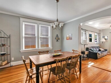 Dining Room with Double Windows and Arches to Family Room/Den addition