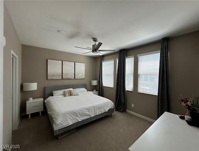Bedroom featuring dark carpet and a ceiling fan