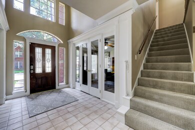 Through the lovely glass double doors lies your private home office, while this first of two carpeted staircases provides easy access to the second-floor.
