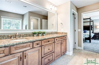Master suite bathroom with double vanity, all glas