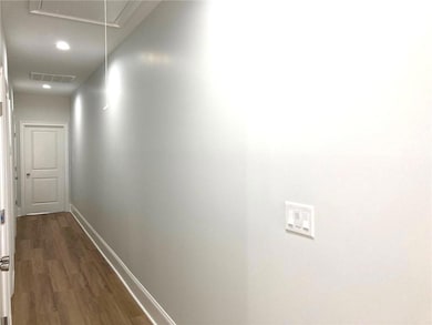Long hallway with roomy closet and laundry closet