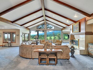 Grand Living Room with vaulted beam ceiling and la