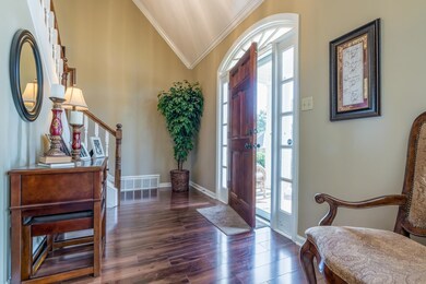 Entrance foyer featuring lofted ceiling, crown mol