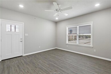 Foyer with dark wood-type flooring and ceiling fan