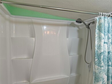 Bathroom featuring shower / tub combo with curtain