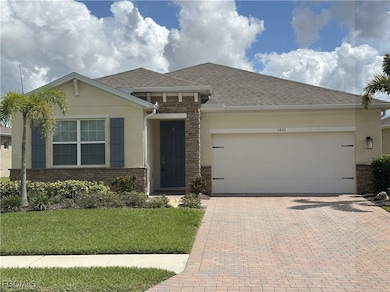 View of front facade featuring stone siding, stucco siding, decorative driveway, a garage, and a shingled roof