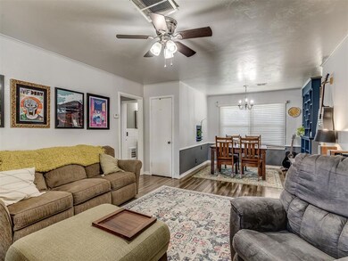 Living room featuring ceiling fan with notable cha