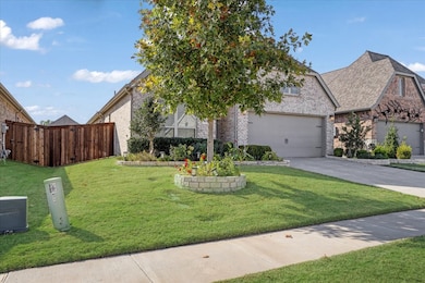 View of front of property featuring brick siding, a front yard, and concrete driveway
