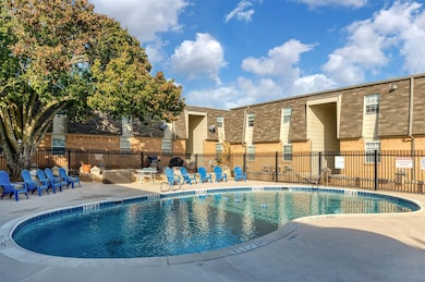 Community pool featuring a patio