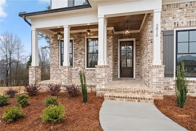 View of exterior entry with a porch and brick siding