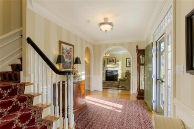 Foyer- arched doorways and beautiful millwork, fau
