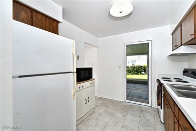 Kitchen featuring freestanding refrigerator, black