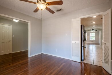 Unfurnished room featuring ceiling fan, a textured