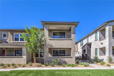 View of front facade featuring stucco siding, a ba