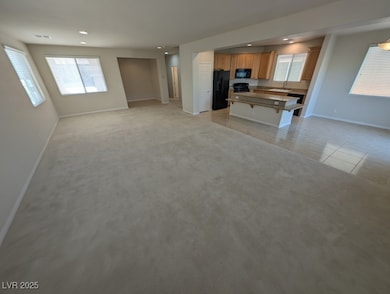 Kitchen with open floor plan, a kitchen bar, a center island, plenty of natural light, and recessed lighting