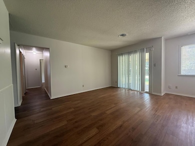 Empty room featuring dark wood-type flooring and 