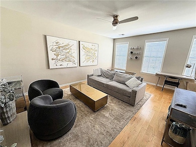 Living room featuring hardwood / wood-style flooring and a ceiling fan