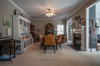 Dining space featuring ornamental molding, light c