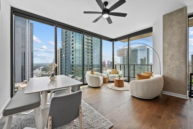 Dining room with a view of city, ceiling fan, woo