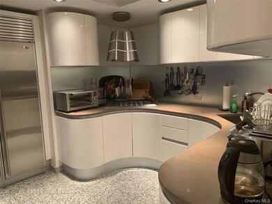 Kitchen with appliances with stainless steel finishes, white cabinets, modern cabinets, and recessed lighting