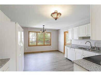 Kitchen features upgraded lights - new floor - dis