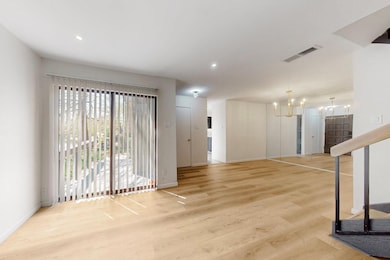 Unfurnished living room with visible vents, basebo