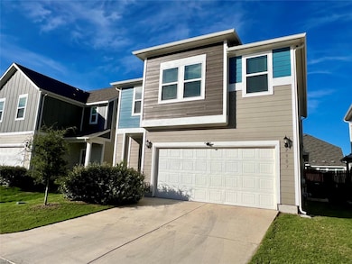 View of front of home featuring a garage and driveway