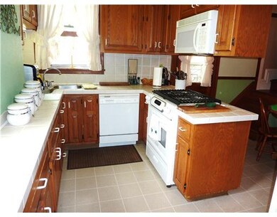 Kitchen. Ample rich wood cabinetry highlights this