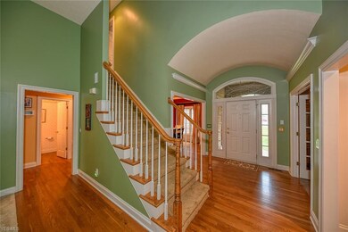 Arched ceiling and hardwood floors graces the foye