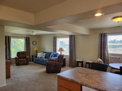 Living room featuring healthy amount of natural light and light carpet
