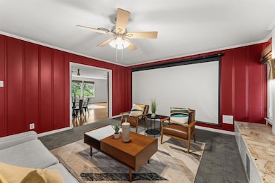 Carpeted cinema room with crown molding, a ceilin