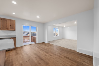 Unfurnished living room featuring light wood-style flooring and recessed lighting