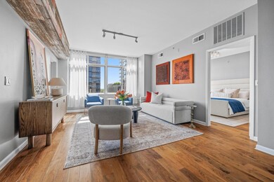 Living area with track lighting, wood-type floori