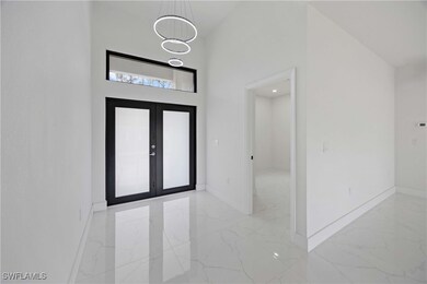 Entrance foyer featuring light marble finish floor