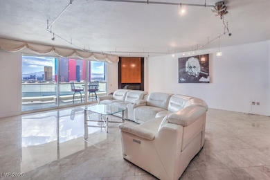 Living room with track lighting and a city view