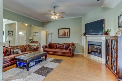 Enjoy comfortable everyday living in the captivating great room flaunting beautiful hardwood floors, soaring ceiling, cooling ceiling fan, fresh paint, French door leading to the backyard, and a cozy gas log fireplace!
