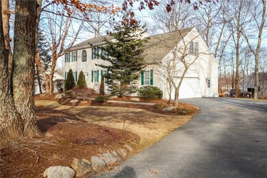 Beautifully landscaped yard leading to 2 car garag
