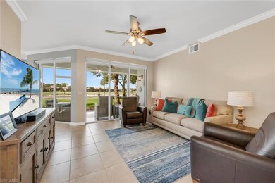 Living area with ceiling fan, ornamental molding, light tile patterned floors, and baseboards