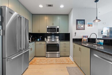 Kitchen with stainless steel appliances, a sink, 