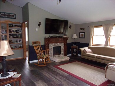 Living room with cathedral ceiling and electric fi