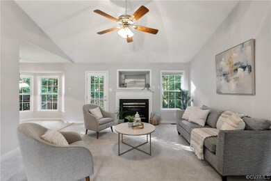 Living room featuring ceiling fan, light carpet, l