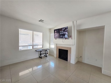 Living room featuring a fireplace, baseboards, and