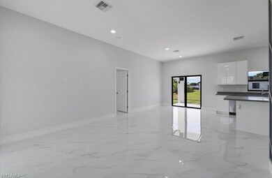 Unfurnished living room featuring light marble finish floors and recessed lighting