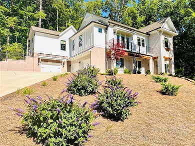View of front of property with a garage and a balc