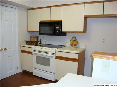 Kitchen features electric stove and microwave -- d