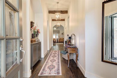Foyer entrance with dark wood finished floors and arched walkways