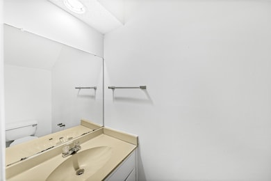 Half bathroom featuring toilet and vanity