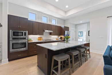Kitchen with light wood finished floors, under ca